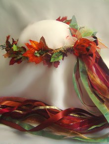 Kayla Forest Fairy, fall leaves and a few 
flowers,  ribbon, in brilliant fall colors.