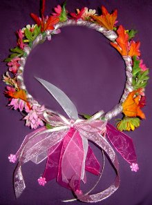 Wreath of bright pinks, yellow flowers and fall leaves.