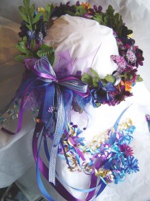 Violet 

Autumn wreath, colorful butterflies, silk daisies, fall flowers and ribbon, in bright blue, purple, oranges, gold.